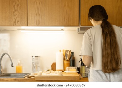 Woman from behind doing dishes in kitchen. Young girl making Breakfast together. Concept of gender equality. - Powered by Shutterstock