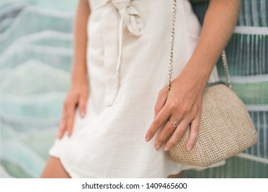 Woman In Beige Dress With Small Bag And Moon Ring On Hand