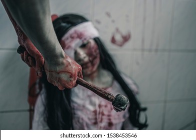 The woman is being attacked by a hammer brutally. Women torture and need help, Halloween murder concept.