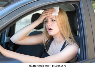 Woman being hot during a heat wave in car 