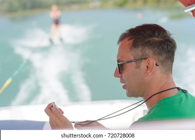 Woman Being Stopped Watched By Waterski Instructor