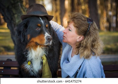 woman with bernese mountain dog on nature