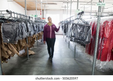 Woman Between Clothes Rail In Sewing Factory Sample Room