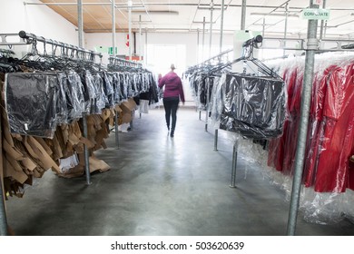 Woman Between Clothes Rail In Sewing Factory Sample Room