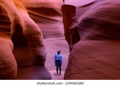 Woman Between Rocks In Antelope Canyon