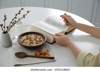 Woman With Bible Having Dinner At Home, Closeup. Great Lent Season