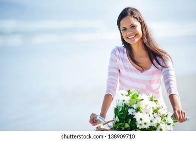 Woman With Bicycle And Flowers In Basket Smiling Carefree And Happy