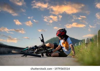 Woman Bicyclist With Mortal Wound And Bleeding Of Blood Flow On The Surface Of Street Road