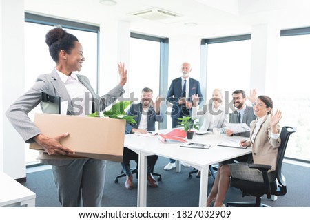 Woman bids goodbye to her colleagues