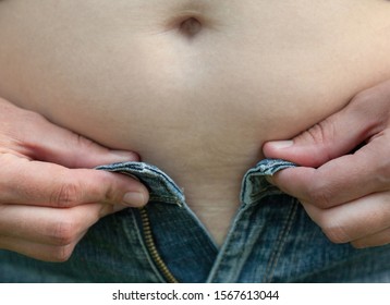 Woman With Big Belly. Jeans That Don't Fit Any More. 