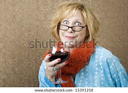Woman with a big grin drinking red wine