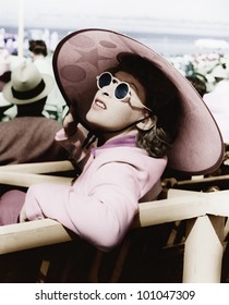 Woman in a big sun hat and sun glasses