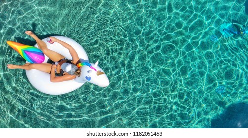 Woman In A Bikini Floating On A Unicorn Floatie