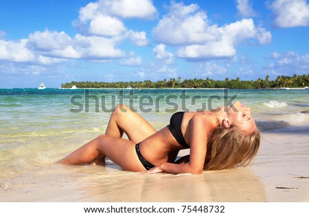 Woman in bikini on caribbean beach in ocean