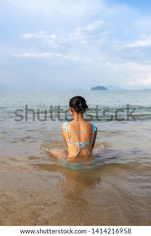 woman in bikini relaxing on the beach