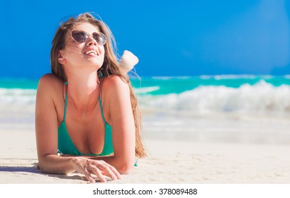 woman in bikini straw hat having lying on tropical beach