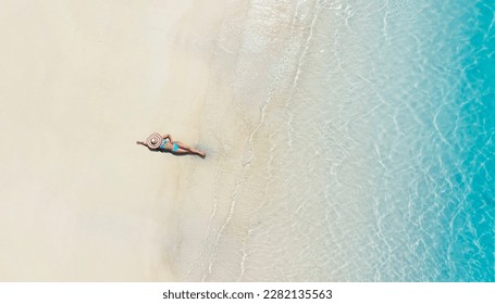 Woman in bikini  sunbathing on the beach of the sea sand and the beach background - Shutterstock ID 2282135563