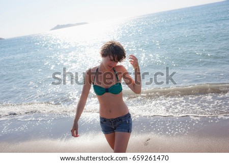 Woman in bikini walking on beach