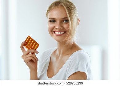 Woman With Birth Control Pills. Beautiful Smiling Girl Holding Blister Pack With Oral Contraceptive Pills. Healthy Happy Girl With Pill Package In Hand. Medicine, Health Care Concept. High Resolution