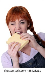 Woman Biting Into Block Of Cheese