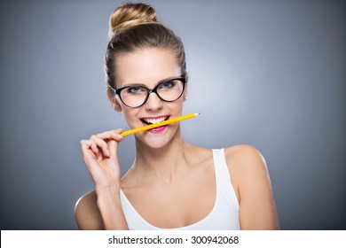 Woman Biting A Pencil
