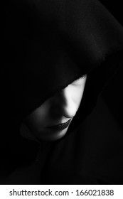 Woman in black cape from above looking depressed artistic conversion