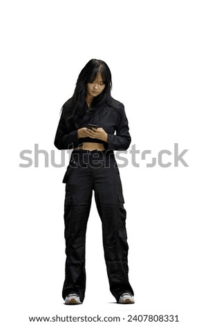 A woman in black clothes, on a white background, full-length, with a phone