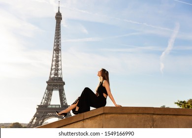 Woman In Black Dress Near Eiffel Tower. Paris Fashion