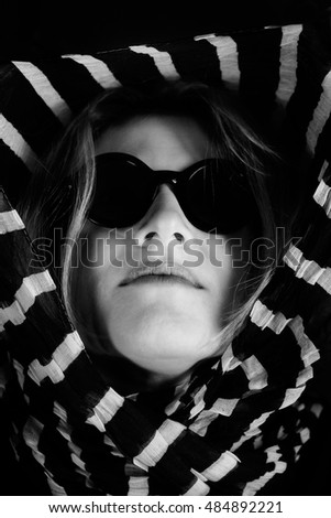 Similar – fashionable girl in black glasses sitting on an iron barrel