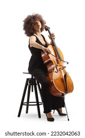 Woman in a black dress sitting on a chair and playing a cello isolated on white background