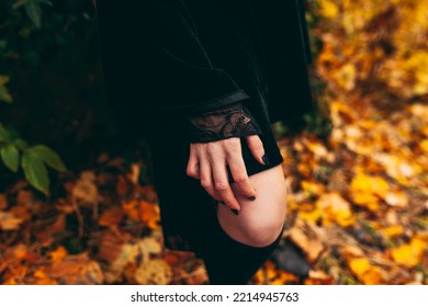 Woman In Black Dress Standing In The Forest, Leaning With Hand On Her Knee, Bare Skin, Detail, No Face 