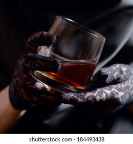 Woman In Black Gloves With Glass Of Whiskey