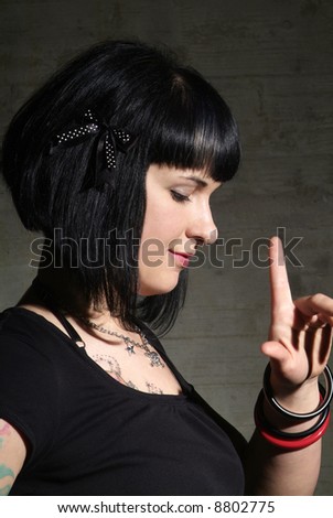 a woman with black hair and tattoo