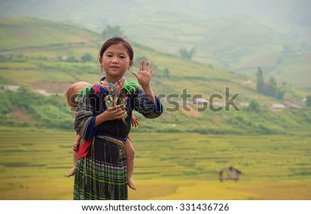 Woman from black hmong hill tribe, children girl smile,Tu Le Lao Cai,Vietnam.