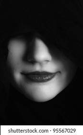 Woman in black hood in black and white