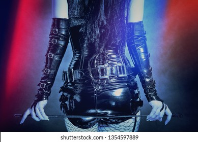 Woman In Black Latex Corset, With Horsewhip In Hands