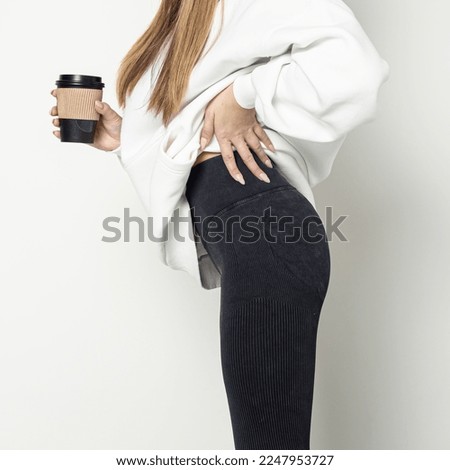 Woman in black leggings. Square. Sporty booty. Push up fit
