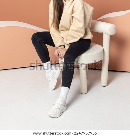Woman in black leggings and white sneakers.Space for text. Casual sports style. Slimming leggings