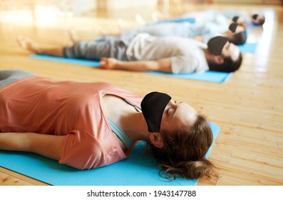 Woman In Black Mask Doing Group Yoga At Studio