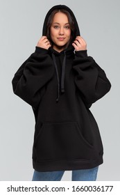 Woman In Black Oversize Hoodie, Mockup For Logo Or Branding Design