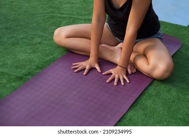 Woman In Black Shirt Doing Morning Yoga On The Purple Mat. Place For Text, Yoga Background