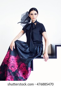 Woman In Black Shirt And Long Skirt With Floral Print Posing On Stairs