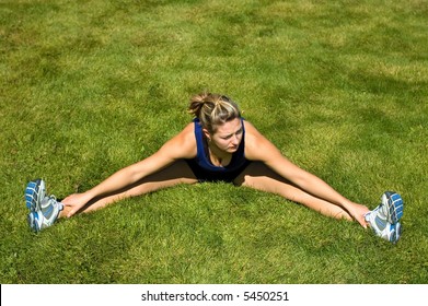 Woman In Black Shorts Stretching Her Groin Muscles.