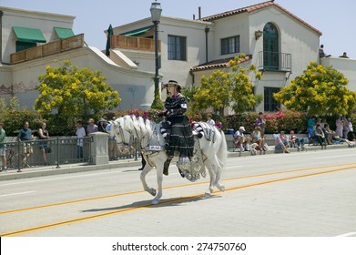 Woman with black Spanish dress riding horse during opening day parade down State Street, Santa Barbara, CA, Old Spanish Days Fiesta, August 3-7, 2005