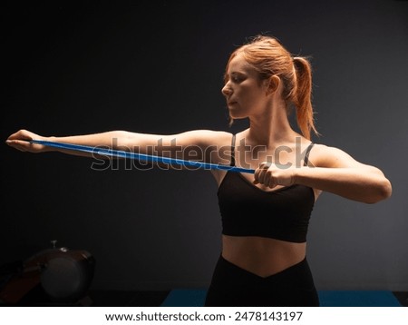 Similar – Close up side view profile portrait of one young middle age athletic woman shadow boxing in sportswear in gym over dark background, looking away