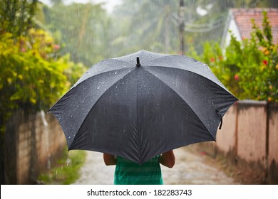 Woman With Black Umbrella In Heavy Rain