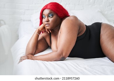 Woman In Black Underwear With Satisfaction On Face Accepts Curvy Body Shape While Laying