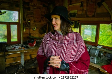 Woman In Blacksmith Shop. Interior Of An Old Forge.