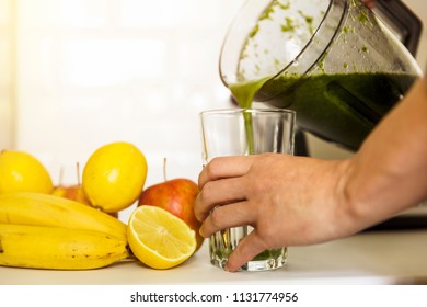 Woman blending spinach, bananas, lemon and apples to make a healthy green smoothie. Healthy living concept - Powered by Shutterstock