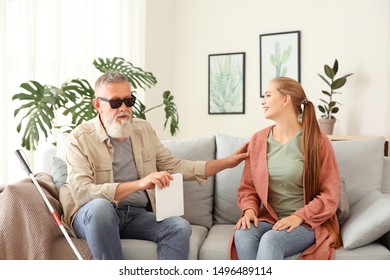 Woman with blind mature man at home - Powered by Shutterstock